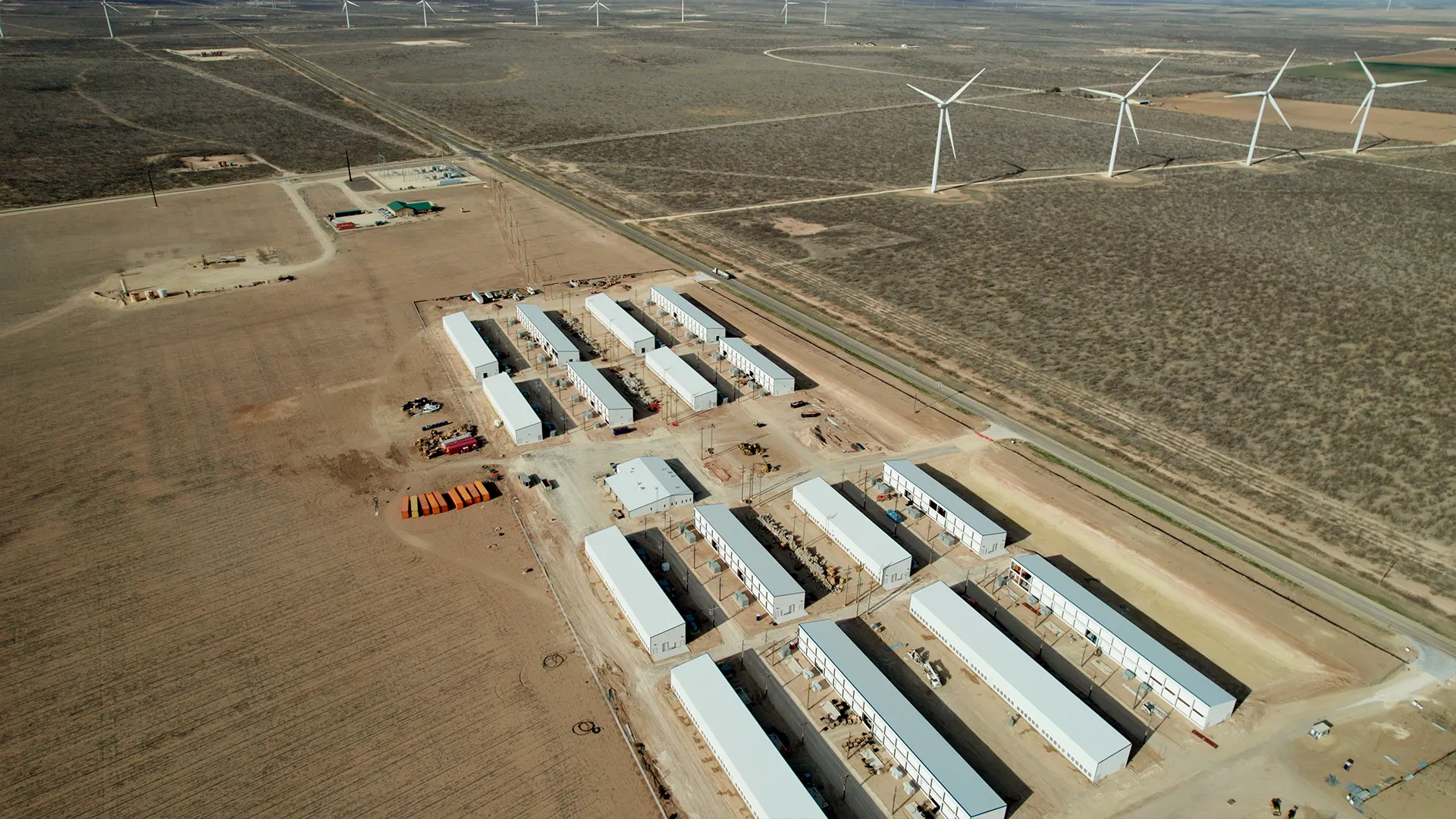A zoomed out view of a wind powered MARA bitcoin mining outdoor container facility.